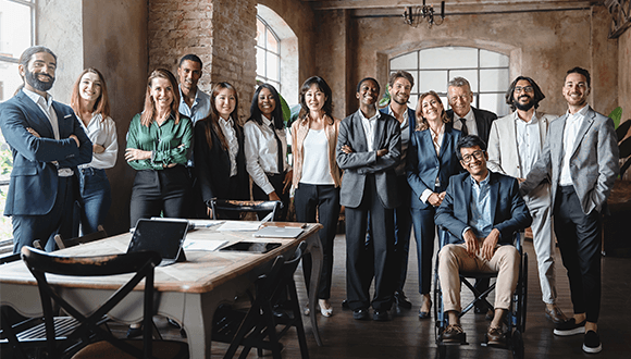 Corporate portrait of a multigenerational working team with multiracial and disabled members - Group photo of colleagues standing in the office in co-working space - business lifestyle concept.
