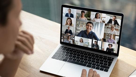 Individual team members displayed on a laptop screen using Zoom for a video call