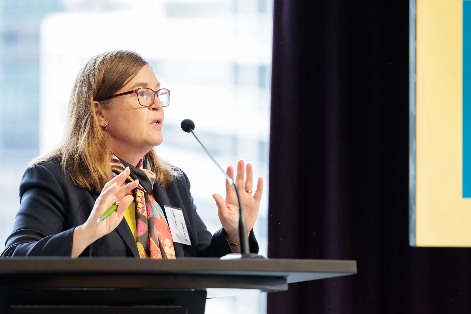 Woman presenting at a lectern