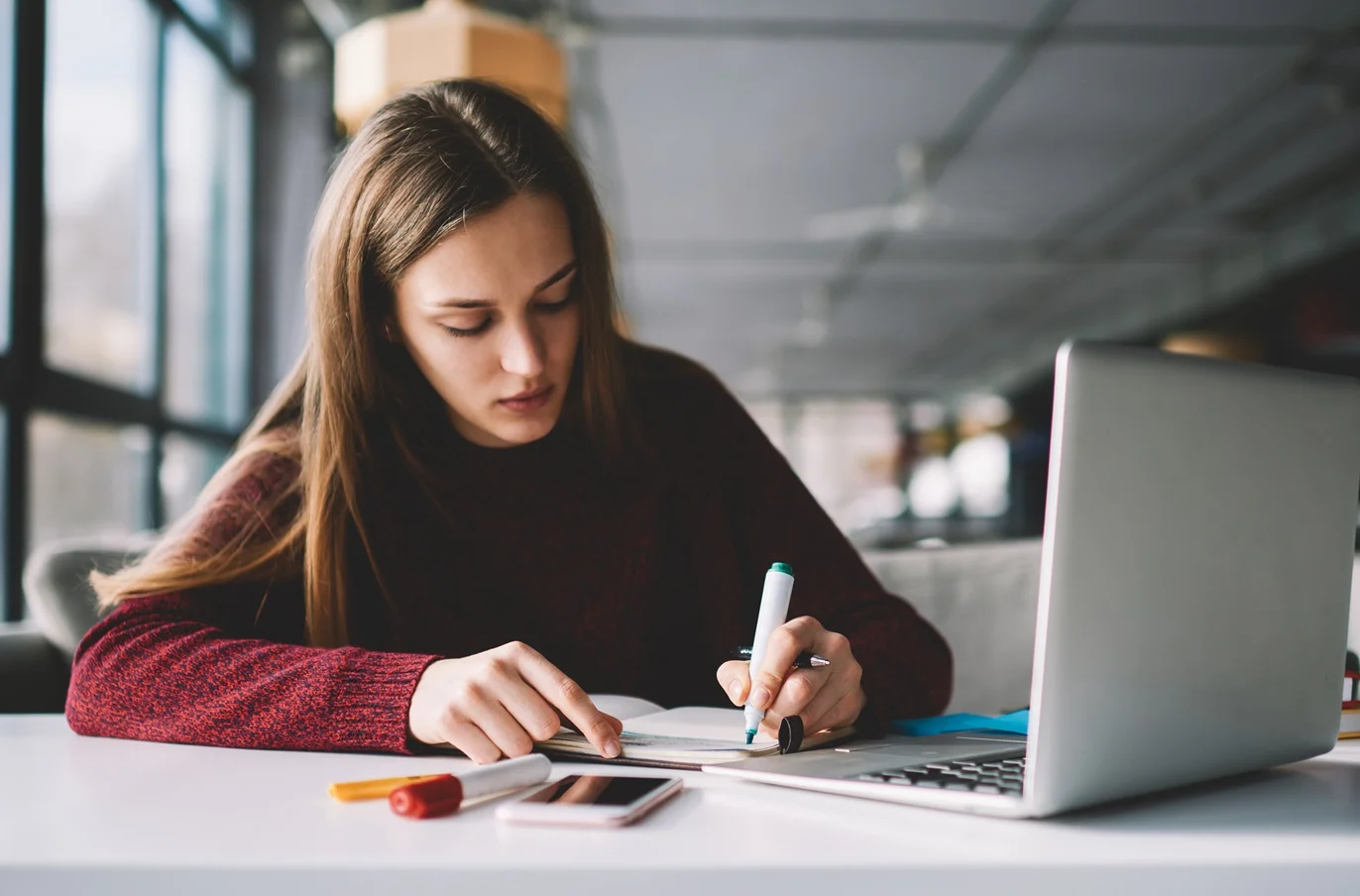 Female student sitting at a desk with laptop computer open