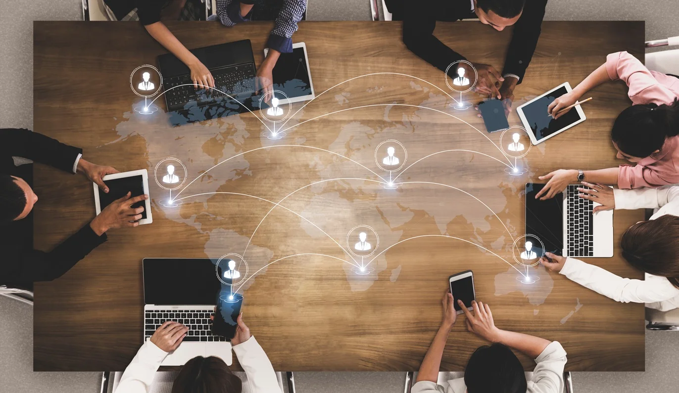 academics, students, or professionals from different countries working together around a table