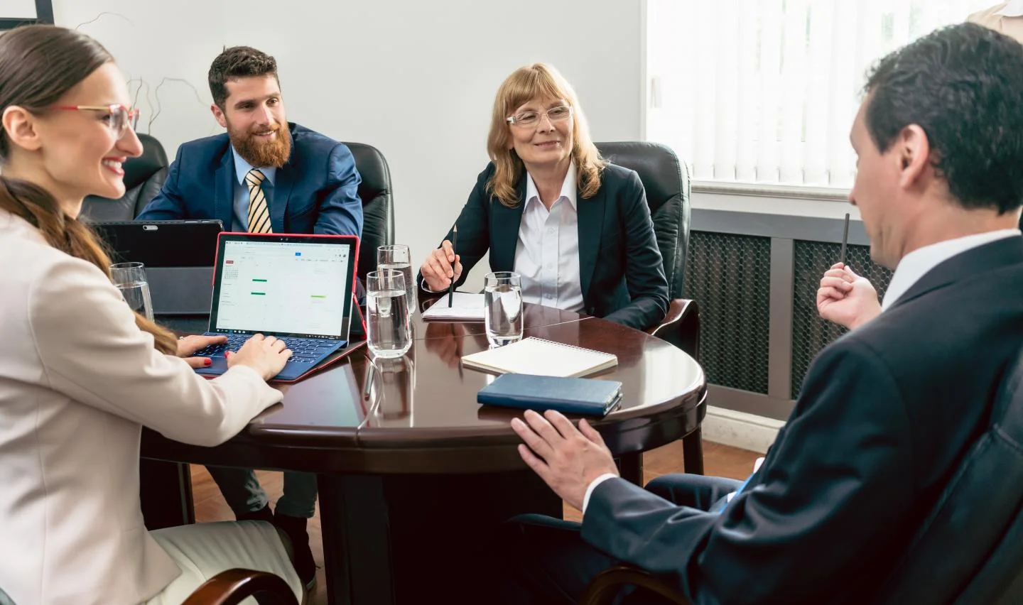 4 people working around a table