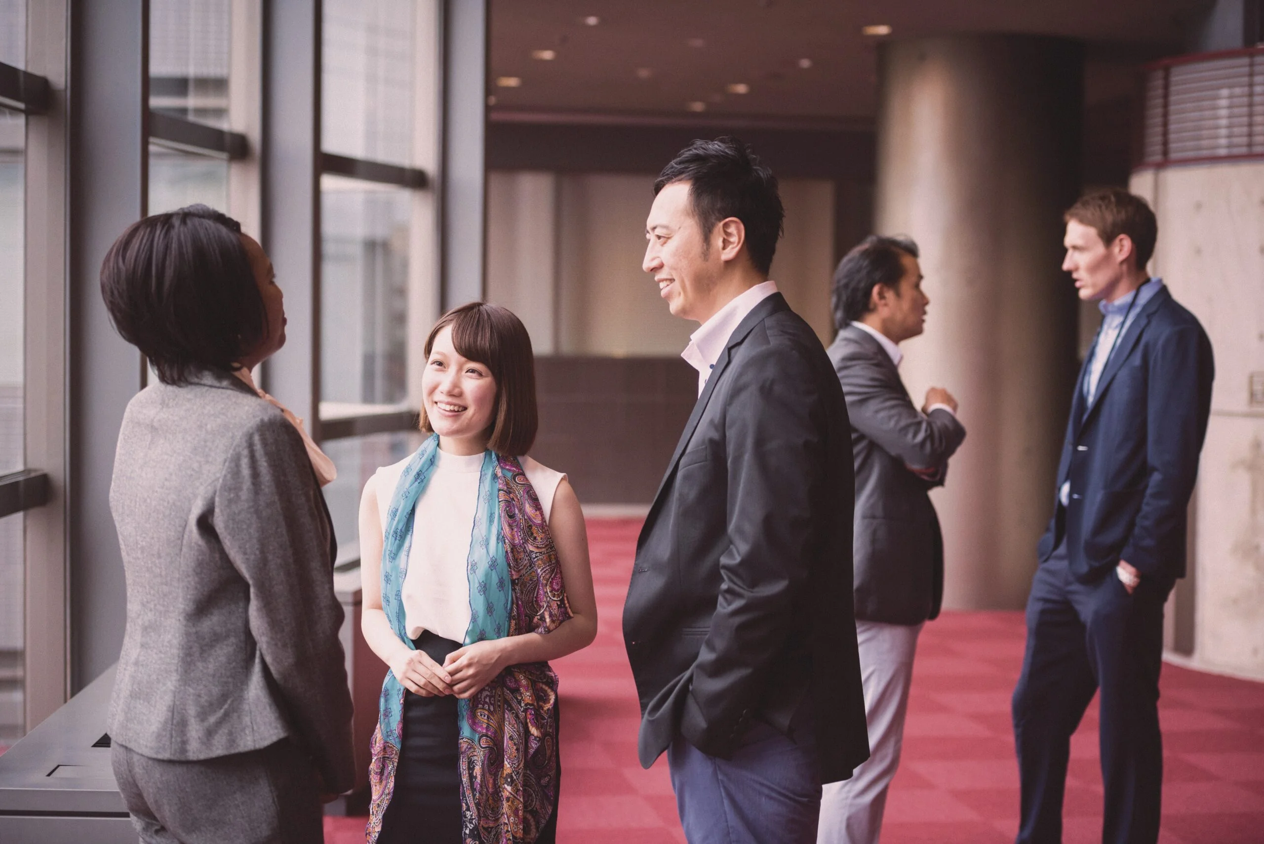 Staff and students talking in a university.