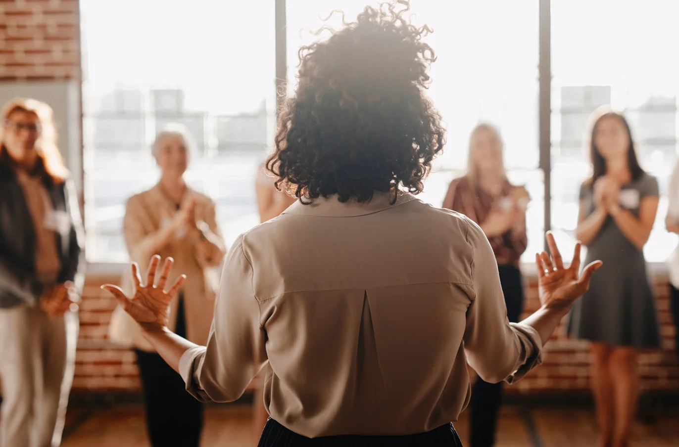 Female empowering other colleagues in workplace