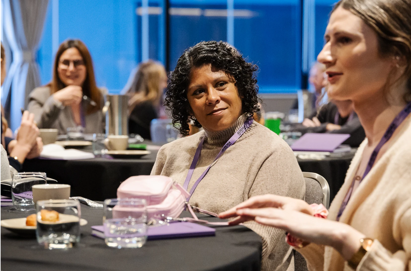 A person listening to another person participating at a conference.