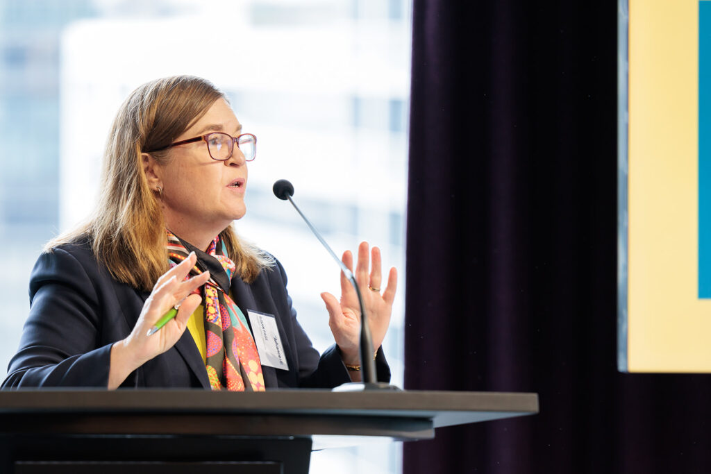 Woman presenting at a lectern