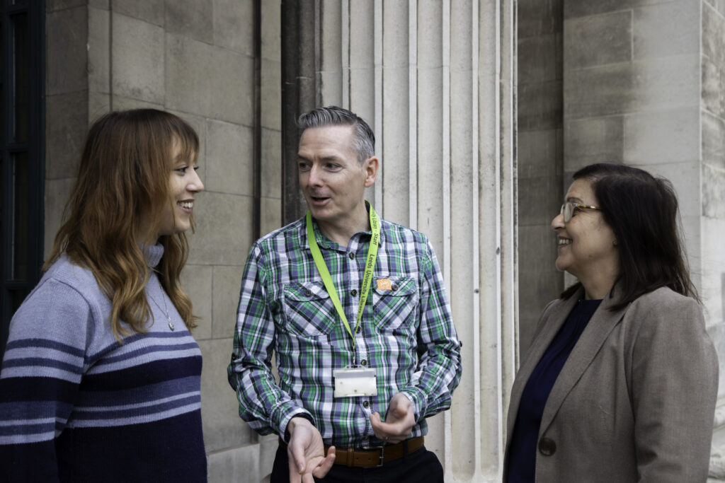 Three people talking in a group