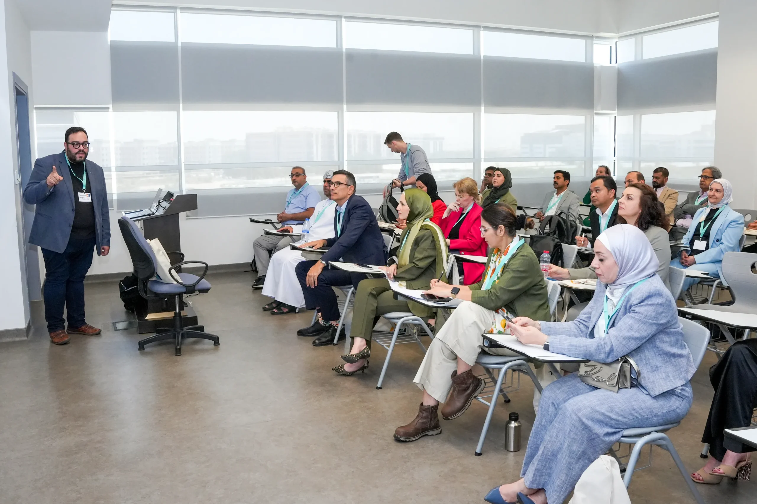 Man presenting to room of people sat at desks